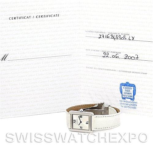 The image shows a Cartier Tank Solo W1019555 Women's Stainless Steel Silver Dial W1019555 Women's Stainless Steel Silver Dial watch placed in front of its certificate showing serial number and date of purchase.