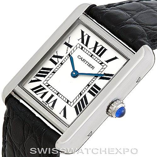 The image shows a Cartier Tank Solo W1018255 Women's Stainless Steel Silver Dial W1018255 Women's Stainless Steel Silver Dial watch from an angled top view, highlighting its Roman numeral dial, blue hands, and black leather strap.