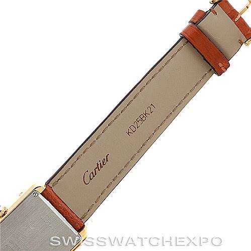 This image shows the underside of a Cartier Tank Solo W1018755 Women's Steel and Gold (two tone) Silver Dial W1018755 Women's Steel and Gold (two tone) Silver Dial watch strap in beige leather with the brand name and a serial number.