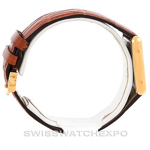 This image shows a side view of the Tank Solo Cartier watch, highlighting the gold case and brown leather strap.