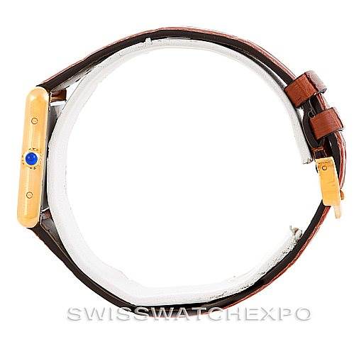 This image shows a side view of the Cartier Tank Solo W1018755 Women's Steel and Gold (two tone) Silver Dial W1018755 Women's Steel and Gold (two tone) Silver Dial watch, displaying its leather strap, gold case, and blue cabochon crown.