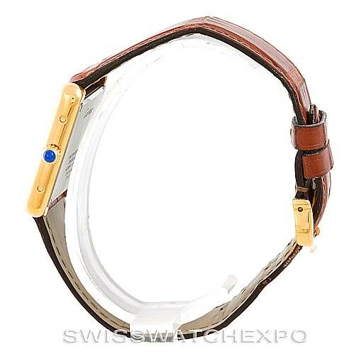 The image shows a side angle of the Cartier Tank Solo W1018755 Women's Steel and Gold (two tone) Silver Dial W1018755 Women's Steel and Gold (two tone) Silver Dial watch, highlighting the gold case, crown with a blue cabochon, and brown leather strap.