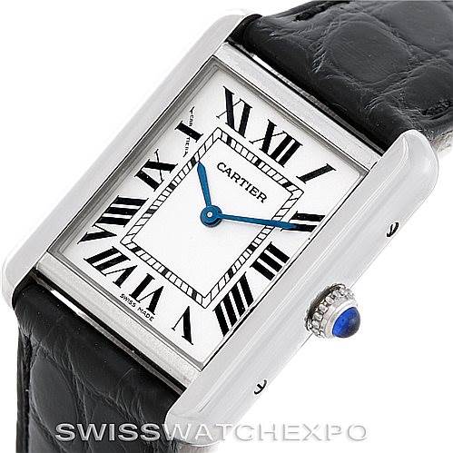 The image shows a Cartier Tank Solo W1018255 Women's Stainless Steel Silver Dial W1018255 Women's Stainless Steel Silver Dial watch at an angled view displaying its rectangular face, Roman numerals, blue hands, and crown with a blue gem.