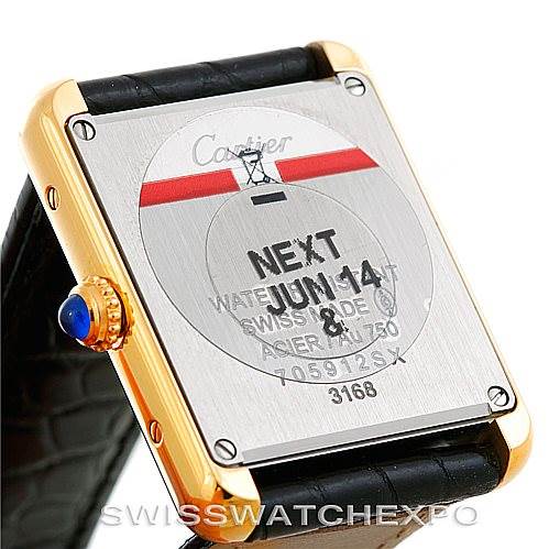 The image shows the back case of a Cartier Tank Solo W1018755 Women's Steel and Gold (two tone) Silver Dial W1018755 Women's Steel and Gold (two tone) Silver Dial watch, highlighting its serial numbers and a portion of the strap.