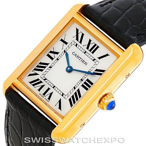 This image shows the face and strap of a Tank Solo model by Cartier, highlighting the gold case, Roman numeral markers, and blue crown.