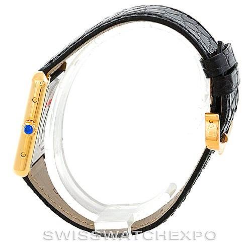 This image shows a side view of a Cartier Tank Solo W1018755 Women's Steel and Gold (two tone) Silver Dial W1018755 Women's Steel and Gold (two tone) Silver Dial watch, including its gold casing, black leather strap, and blue cabochon crown.