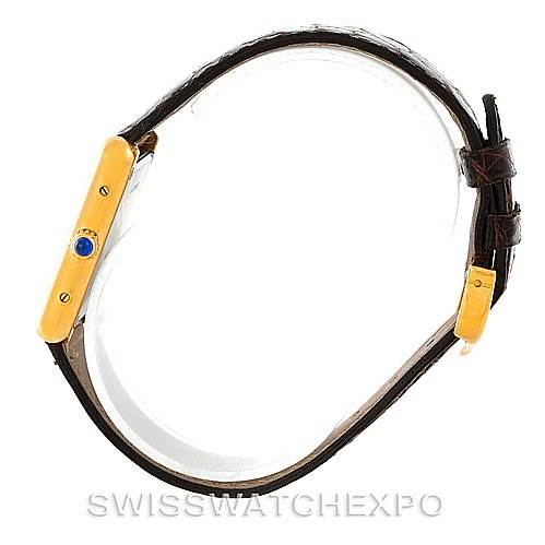 This image shows a side view of a Tank Solo watch by Cartier, highlighting the gold case, crown, and brown leather strap.