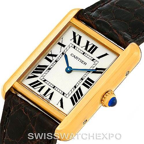 The image shows a close-up angle of the Cartier Tank Solo W1018755 Women's Steel and Gold (two tone) Silver Dial W1018755 Women's Steel and Gold (two tone) Silver Dial watch, highlighting the face, Roman numerals, and crown with a blue cabochon.