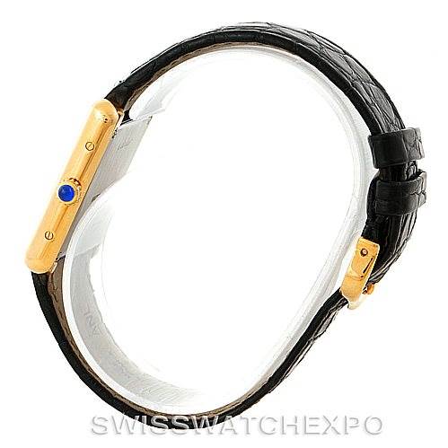 The image shows a side view of the Cartier Tank Solo W1018755 Women's Steel and Gold (two tone) Silver Dial W1018755 Women's Steel and Gold (two tone) Silver Dial watch, highlighting its black strap and gold case with a blue cabochon crown.