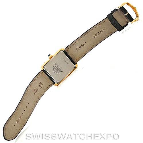 The image shows the back view of a Tank Solo model by Cartier, including the case back and leather strap.