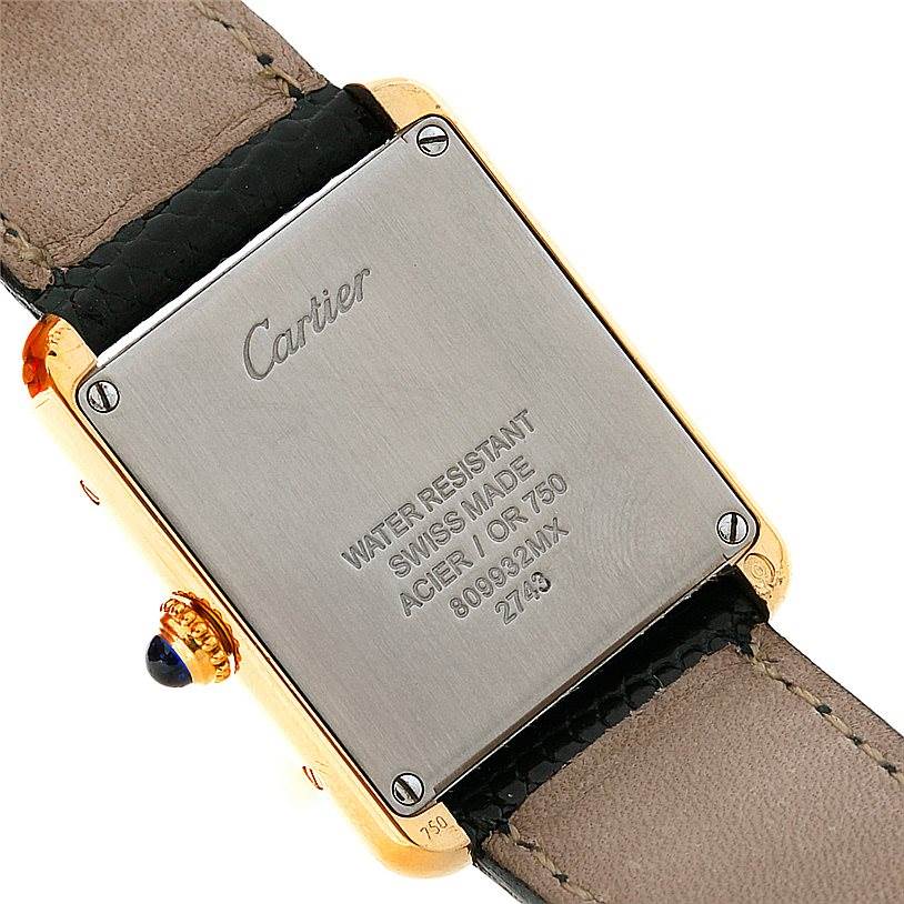 This image shows the back case of the Cartier Tank Solo W1018755 Women's Steel and Gold (two tone) Silver Dial W1018755 Women's Steel and Gold (two tone) Silver Dial watch, highlighting the engravings, straps, and crown.