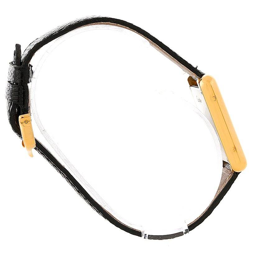 The image shows a side and partial top view of a Cartier Tank Solo W1018755 Women's Steel and Gold (two tone) Silver Dial W1018755 Women's Steel and Gold (two tone) Silver Dial watch with a black strap and rectangular gold case.