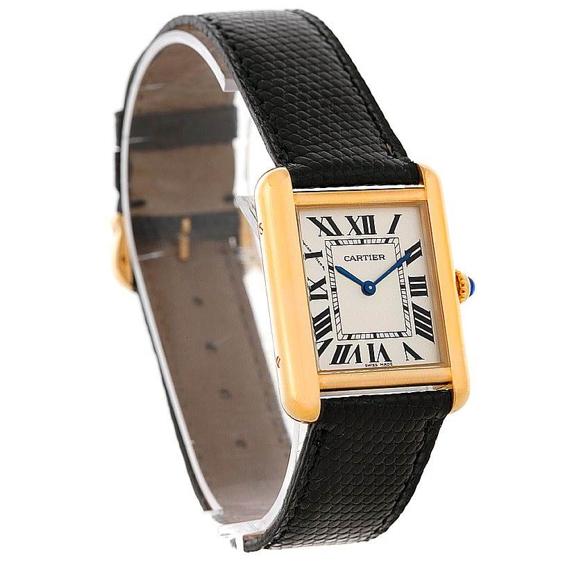 The image shows a Cartier Tank Solo W1018755 Women's Steel and Gold (two tone) Silver Dial W1018755 Women's Steel and Gold (two tone) Silver Dial watch from a close-up side angle, highlighting its black leather strap and rectangular gold case.