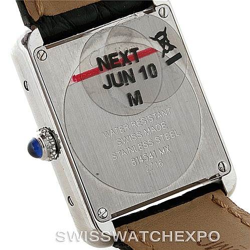 The image shows the back case of a Cartier Tank Solo W1018255 Women's Stainless Steel Silver Dial W1018255 Women's Stainless Steel Silver Dial watch, highlighting its inscriptions and a sticker.