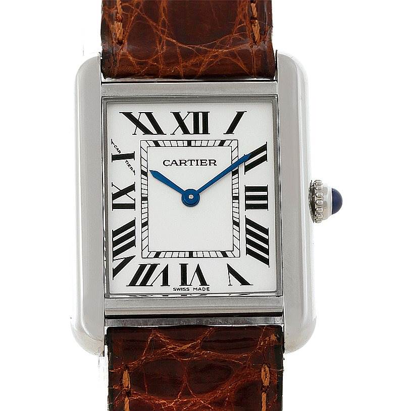 This image shows a frontal view of the Cartier Tank Solo W1018255 Women's Stainless Steel Silver Dial W1018255 Women's Stainless Steel Silver Dial watch, featuring its face, Roman numerals, blue hands, and part of the leather strap.