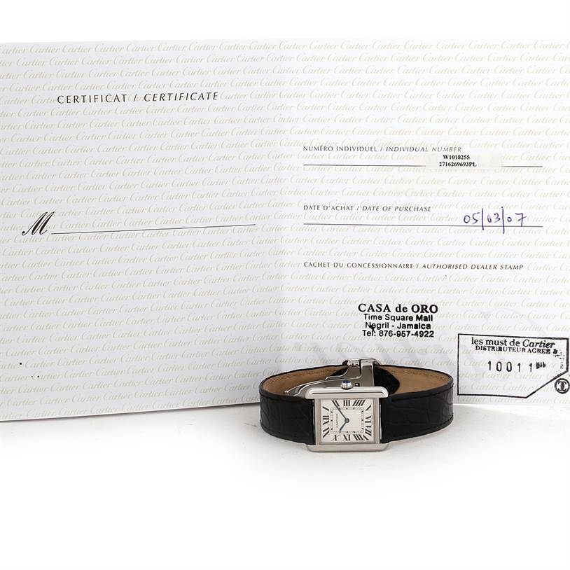 The Cartier Tank Solo W1018255 Women's Stainless Steel Silver Dial W1018255 Women's Stainless Steel Silver Dial watch is shown laid flat with its certificate in the background.