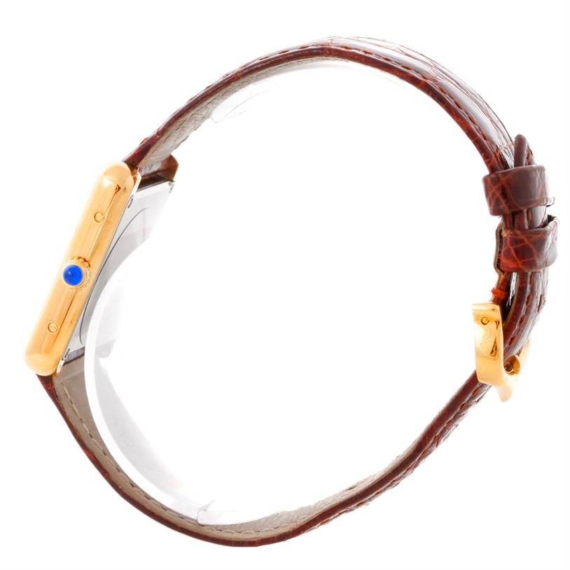 The image shows a side view of the Tank Solo model by Cartier, highlighting the watch's case, crown, and strap.