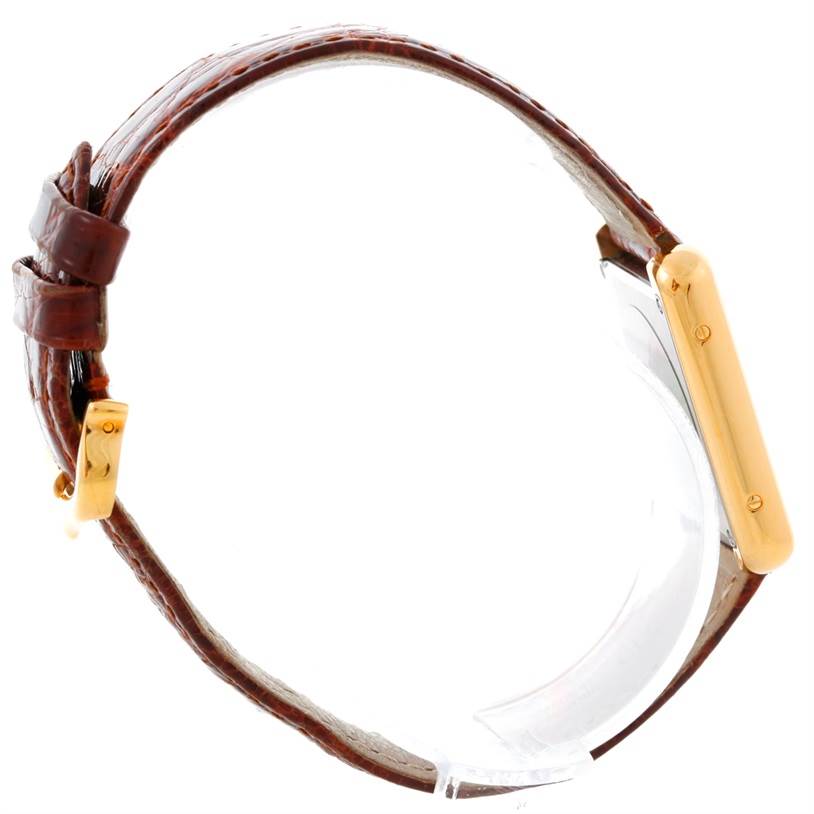 This image shows a side view of a Cartier Tank Solo W1018755 Women's Steel and Gold (two tone) Silver Dial W1018755 Women's Steel and Gold (two tone) Silver Dial watch, highlighting its rectangular gold case and brown leather strap.