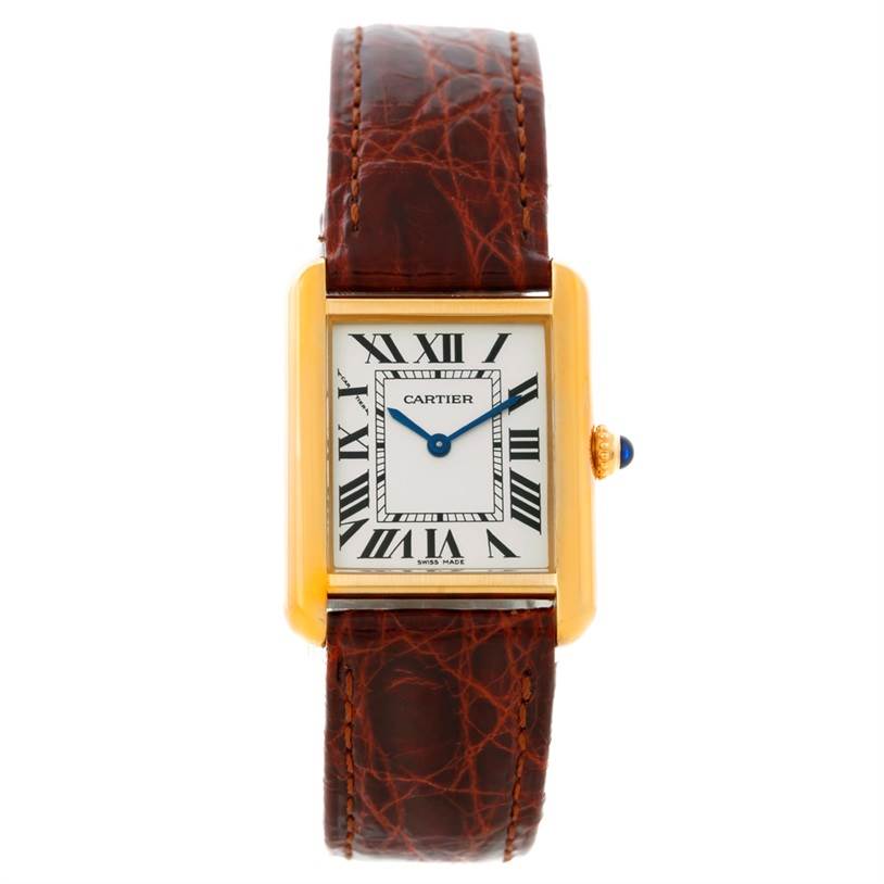The Cartier Tank Solo W1018755 Women's Steel and Gold (two tone) Silver Dial W1018755 Women's Steel and Gold (two tone) Silver Dial watch is shown from a front angle, displaying its face, gold casing, blue hands, and brown leather strap.