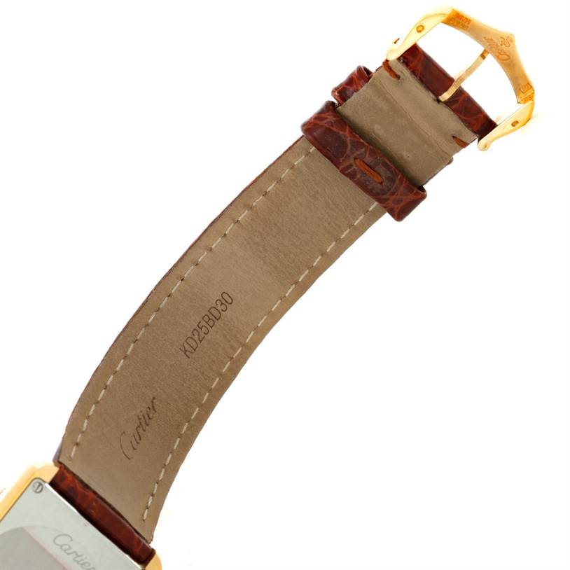 The image shows the inside of the strap and buckle of a Cartier Tank Solo W1018755 Women's Steel and Gold (two tone) Silver Dial W1018755 Women's Steel and Gold (two tone) Silver Dial watch at an angle.