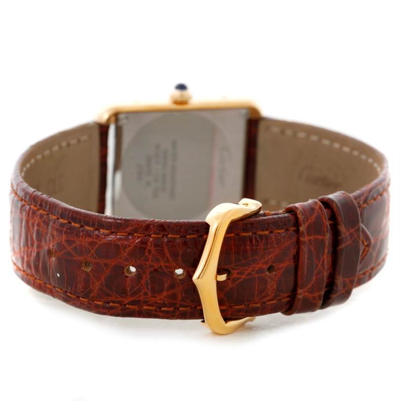 The image shows the back view of a Cartier Tank Solo W1018755 Women's Steel and Gold (two tone) Silver Dial W1018755 Women's Steel and Gold (two tone) Silver Dial watch, highlighting its brown leather strap and gold buckle.