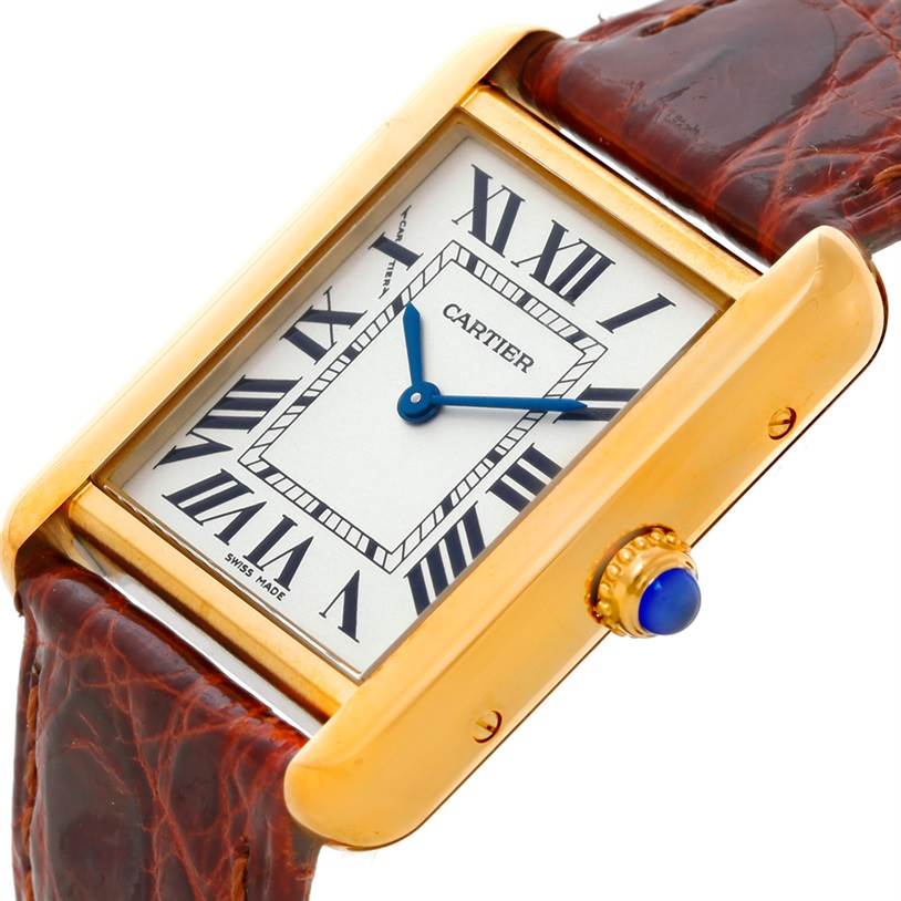 This image shows a close-up of the Cartier Tank Solo W1018755 Women's Steel and Gold (two tone) Silver Dial W1018755 Women's Steel and Gold (two tone) Silver Dial watch, highlighting its rectangular dial, Roman numerals, blue sword-shaped hands, and leather strap.
