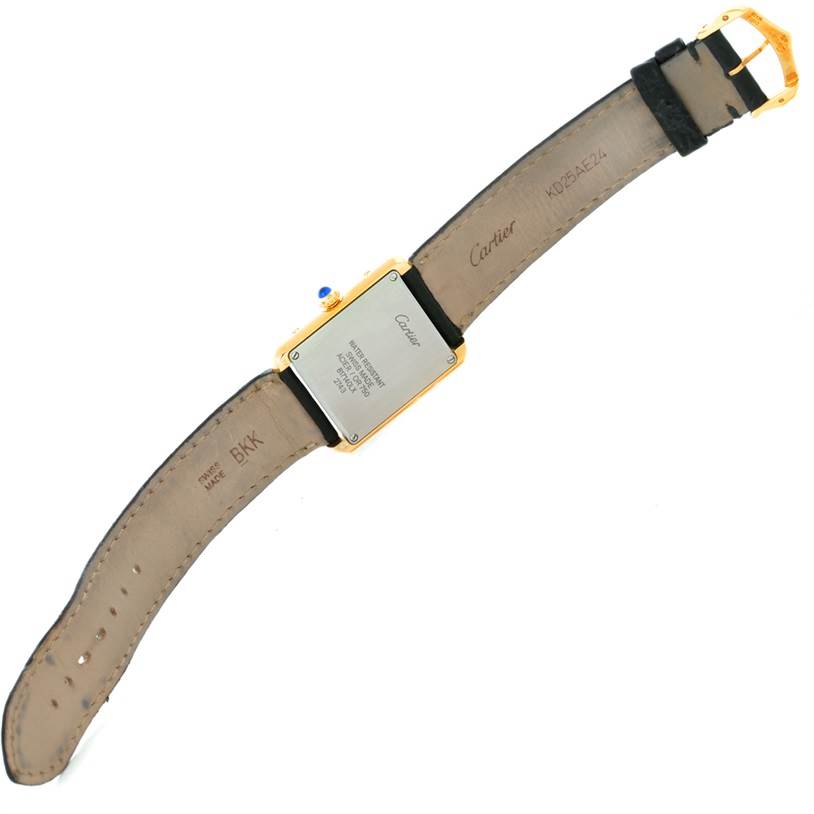 This image shows the back case and strap of a Cartier Tank Solo W1018755 Women's Steel and Gold (two tone) Silver Dial W1018755 Women's Steel and Gold (two tone) Silver Dial watch, including the buckle and brand engravings.