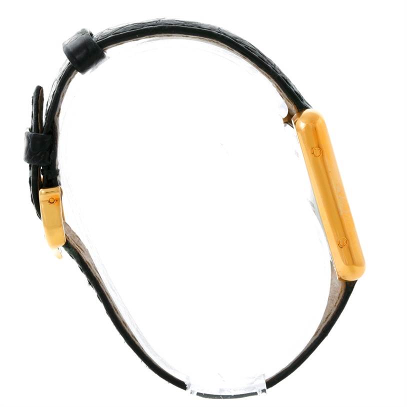 This image shows a Cartier Tank Solo W1018755 Women's Steel and Gold (two tone) Silver Dial W1018755 Women's Steel and Gold (two tone) Silver Dial watch from the side angle, highlighting the gold case and black leather strap.