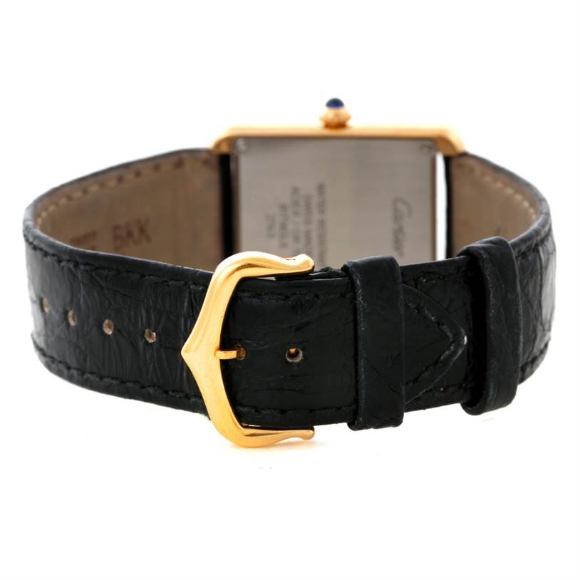 This image shows the back view of a Cartier Tank Solo W1018755 Women's Steel and Gold (two tone) Silver Dial W1018755 Women's Steel and Gold (two tone) Silver Dial watch, highlighting the black leather strap and gold buckle.