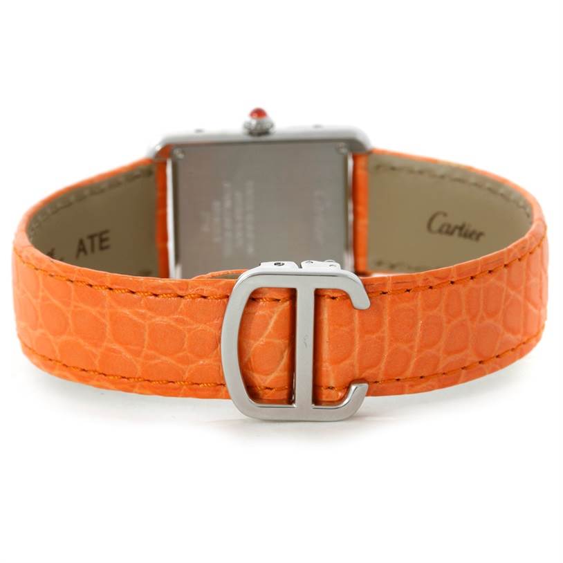 The image shows the back view of a Cartier Tank Solo W1019455 Women's Stainless Steel Orange Dial W1019455 Women's Stainless Steel Orange Dial watch with an orange leather strap and a metal clasp.