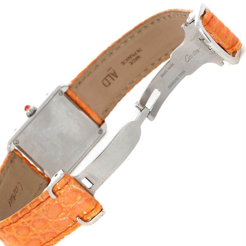 The image shows the back and clasp of the Cartier Tank Solo W1019455 Women's Stainless Steel Orange Dial W1019455 Women's Stainless Steel Orange Dial watch with a partially open orange leather strap.