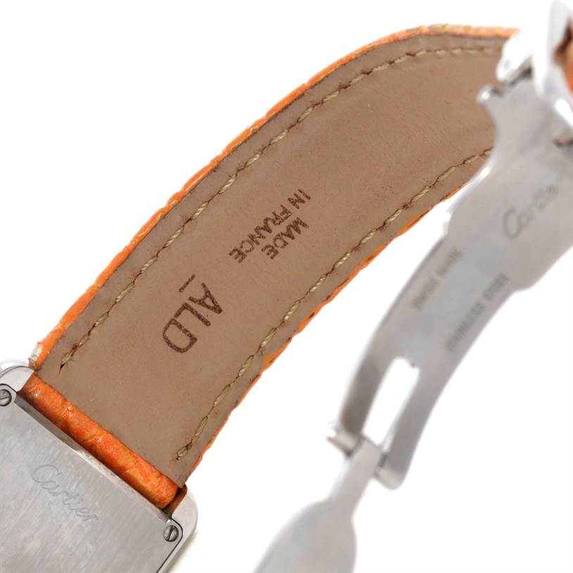 The image shows the underside of the orange leather strap and clasp of a Cartier Tank Solo W1019455 Women's Stainless Steel Orange Dial W1019455 Women's Stainless Steel Orange Dial watch.
