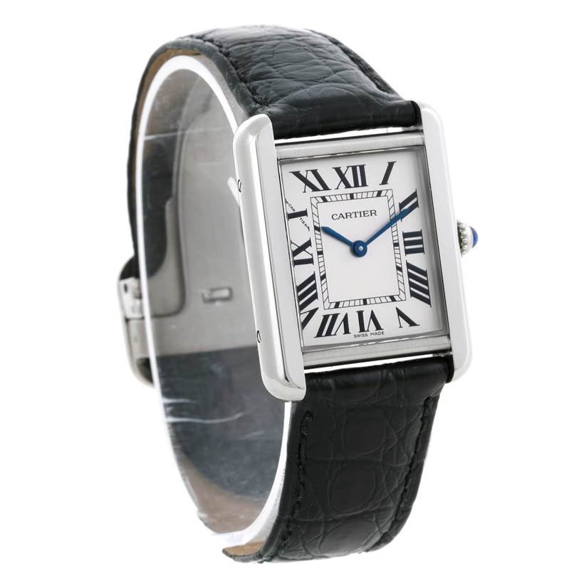 This image shows the Cartier Tank Solo W1018255 Women's Stainless Steel Silver Dial W1018255 Women's Stainless Steel Silver Dial watch at an angle that displays its face, Roman numerals, black leather strap, and crown.