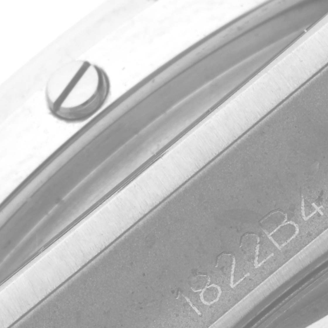 The image shows a close-up of the bezel and engraved serial number on a Breitling Chronomat PB0136 Men's Stainless Steel Blue Dial PB0136 Men's Stainless Steel Blue Dial watch.