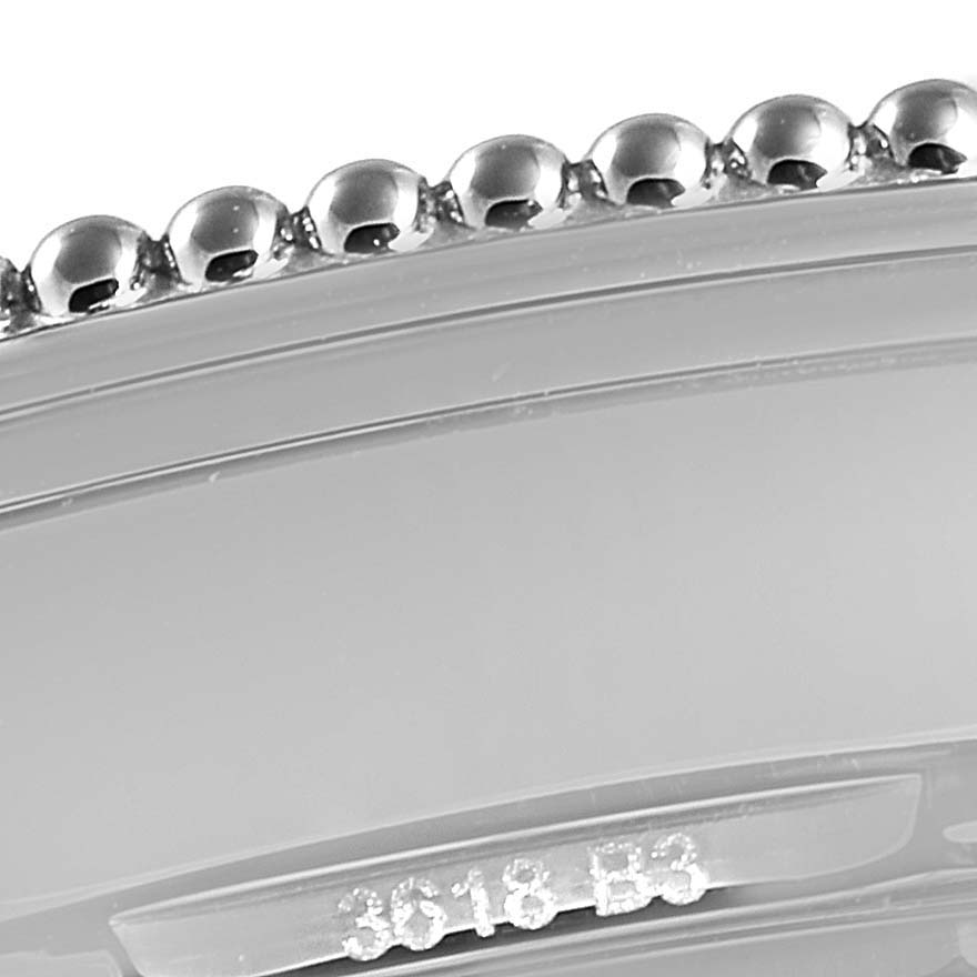 The image shows a close-up of the bezel and part of the casing of a Breitling Navitimer A17325 Men
s Stainless Steel Blue Dial A17325 Men
s Stainless Steel Blue Dial watch.