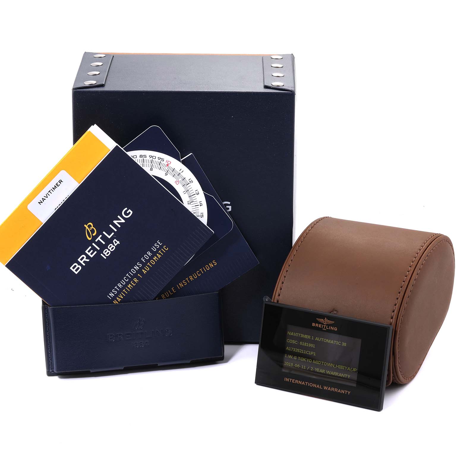 The image shows the packaging and accessories for a Breitling Navitimer A17325 Men
s Stainless Steel Blue Dial A17325 Men
s Stainless Steel Blue Dial watch, including the instruction manual, warranty card, and leather watch case.