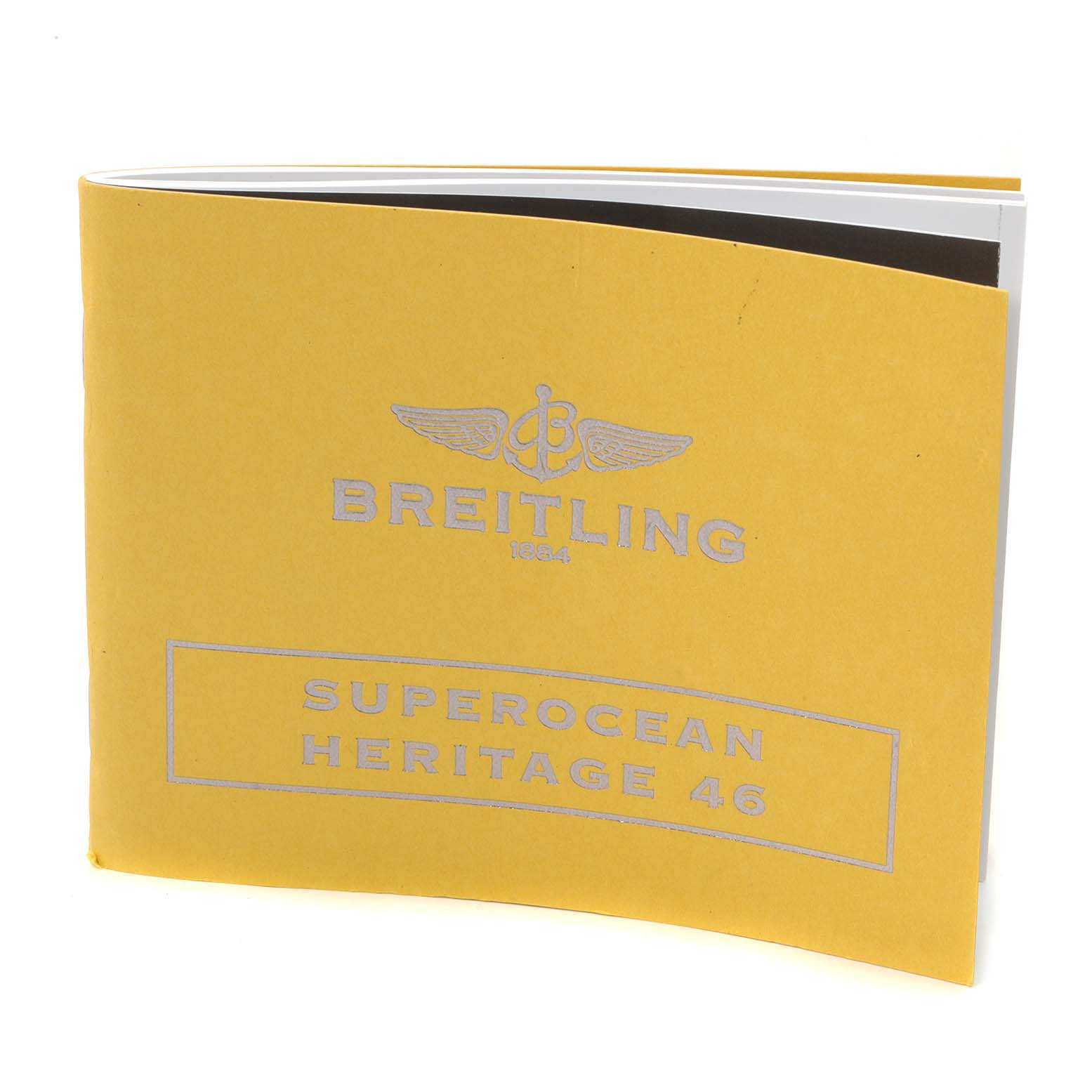 The image shows a yellow booklet for the Breitling Superocean A17320 Men's Stainless Steel Black Dial A17320 Men's Stainless Steel Black Dial Heritage 46 watch, viewed at a slight angle from the front.