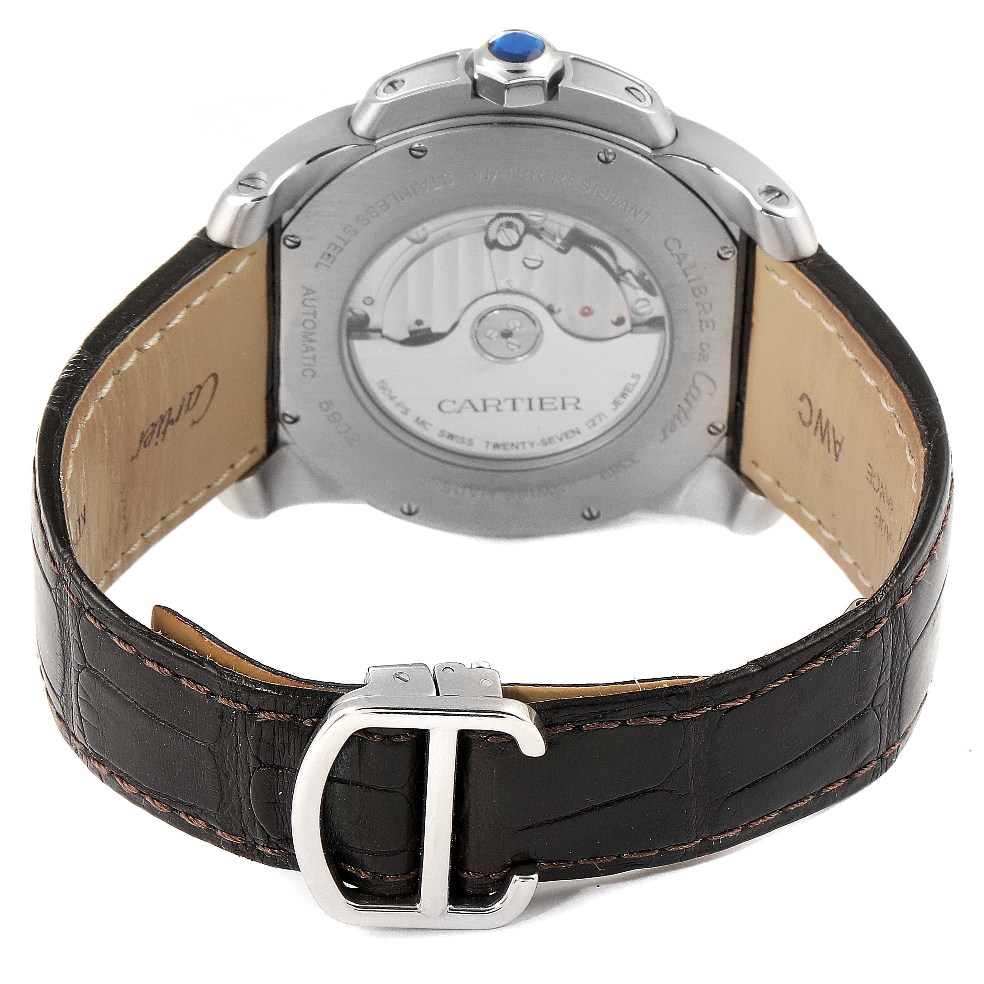 This image shows the back of the Calibre de Cartier watch by Cartier, highlighting the transparent case back and leather strap with buckle.