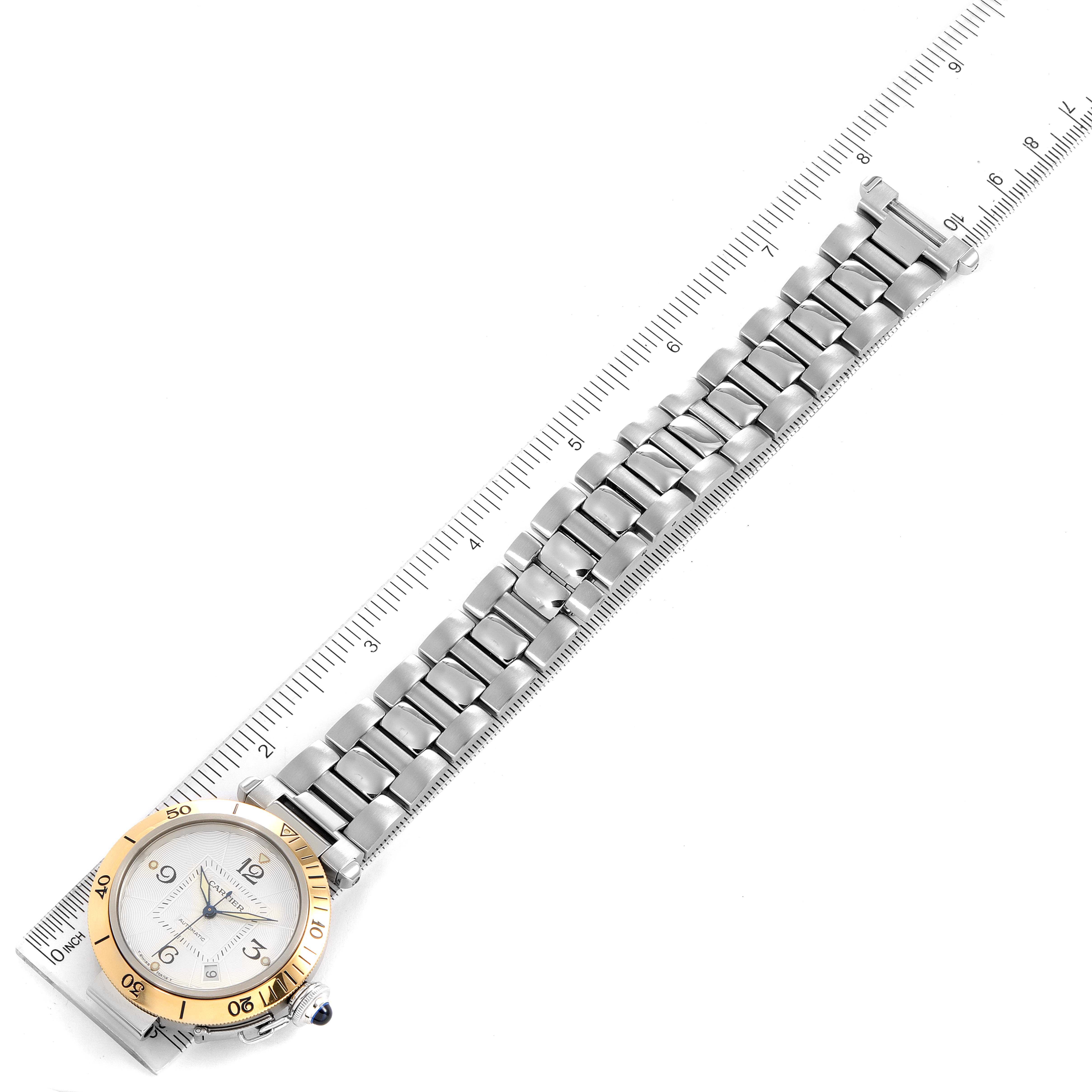 This image shows a Cartier Pasha 2378 Men's Steel and Gold (two tone) Silver Dial 2378 Men's Steel and Gold (two tone) Silver Dial watch laid flat with a ruler for measurement.