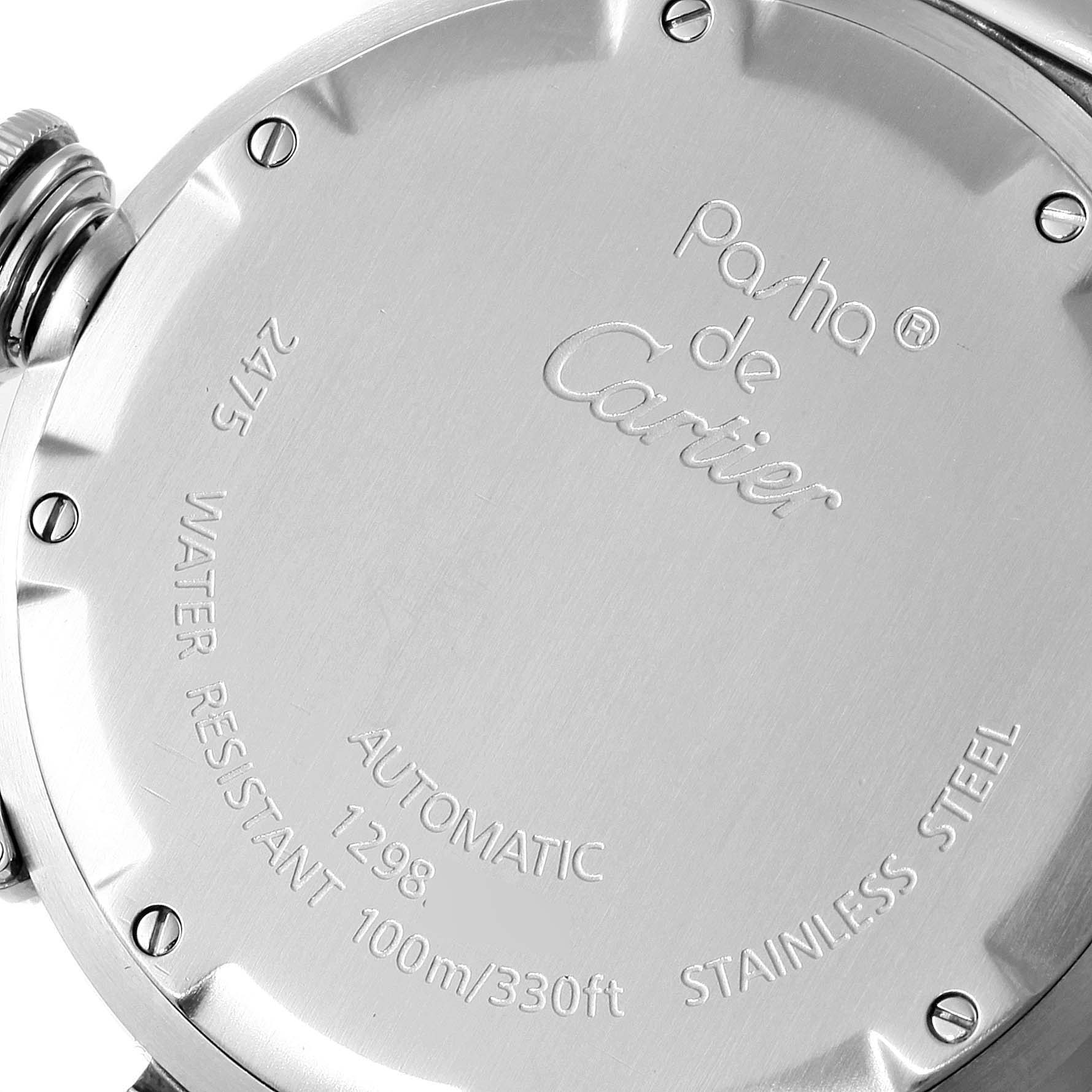 This image shows the back of a Cartier Pasha W31058M7 Men's Stainless Steel Pink Dial W31058M7 Men's Stainless Steel Pink Dial watch, highlighting its inscriptions and screw details.