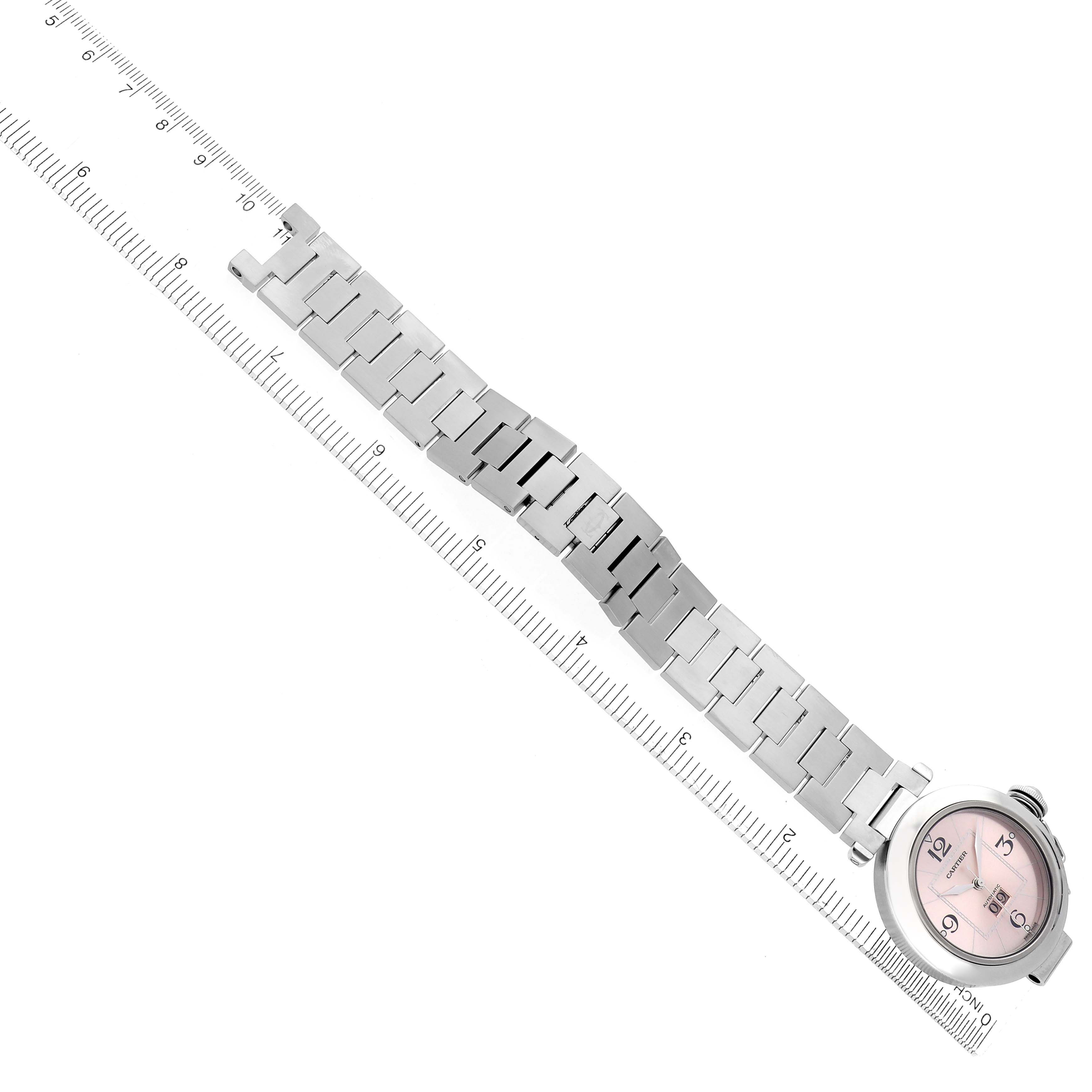 The Cartier Pasha W31058M7 Women
s Stainless Steel Pink Dial W31058M7 Women
s Stainless Steel Pink Dial watch is shown flat with its full metal bracelet, alongside a ruler for scale.