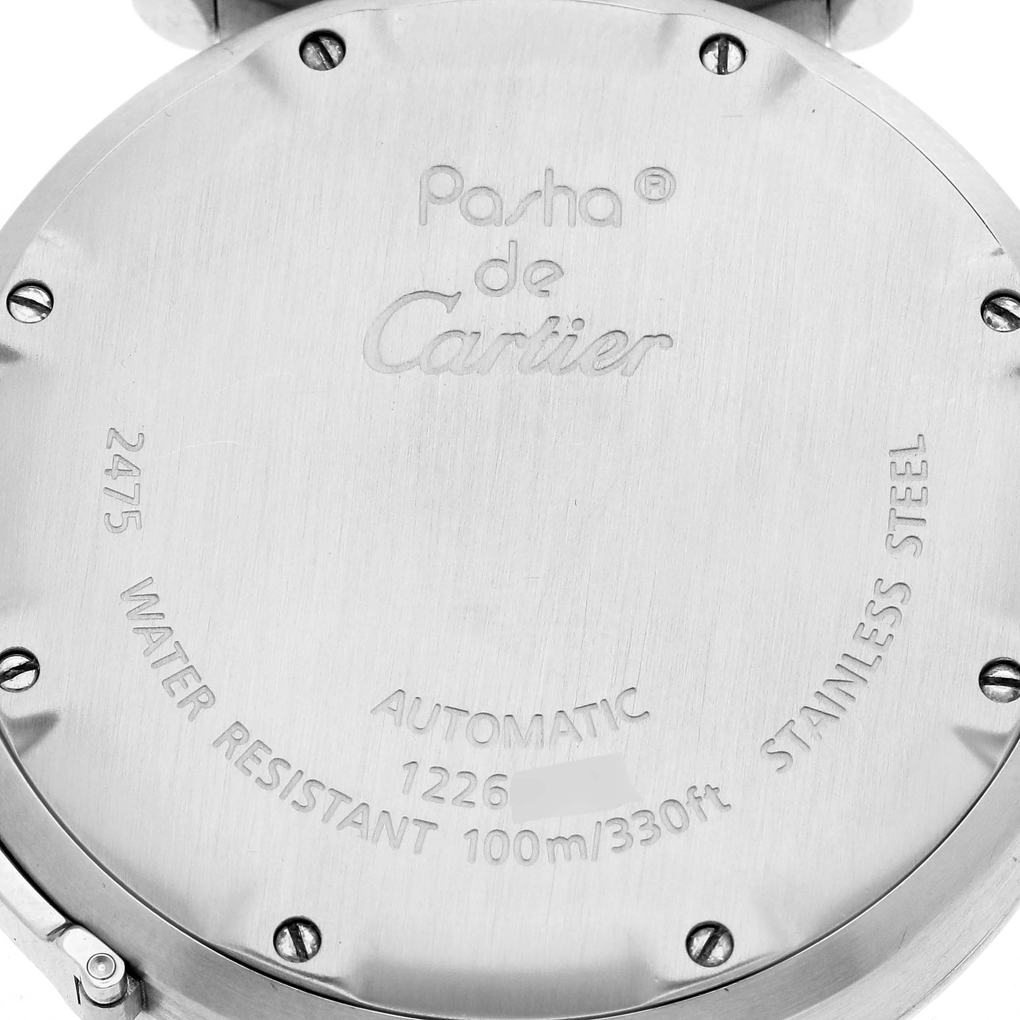The image shows the back of a Cartier Pasha W31058M7 Women
s Stainless Steel Pink Dial W31058M7 Women
s Stainless Steel Pink Dial watch featuring engraved details about the model and specifications.