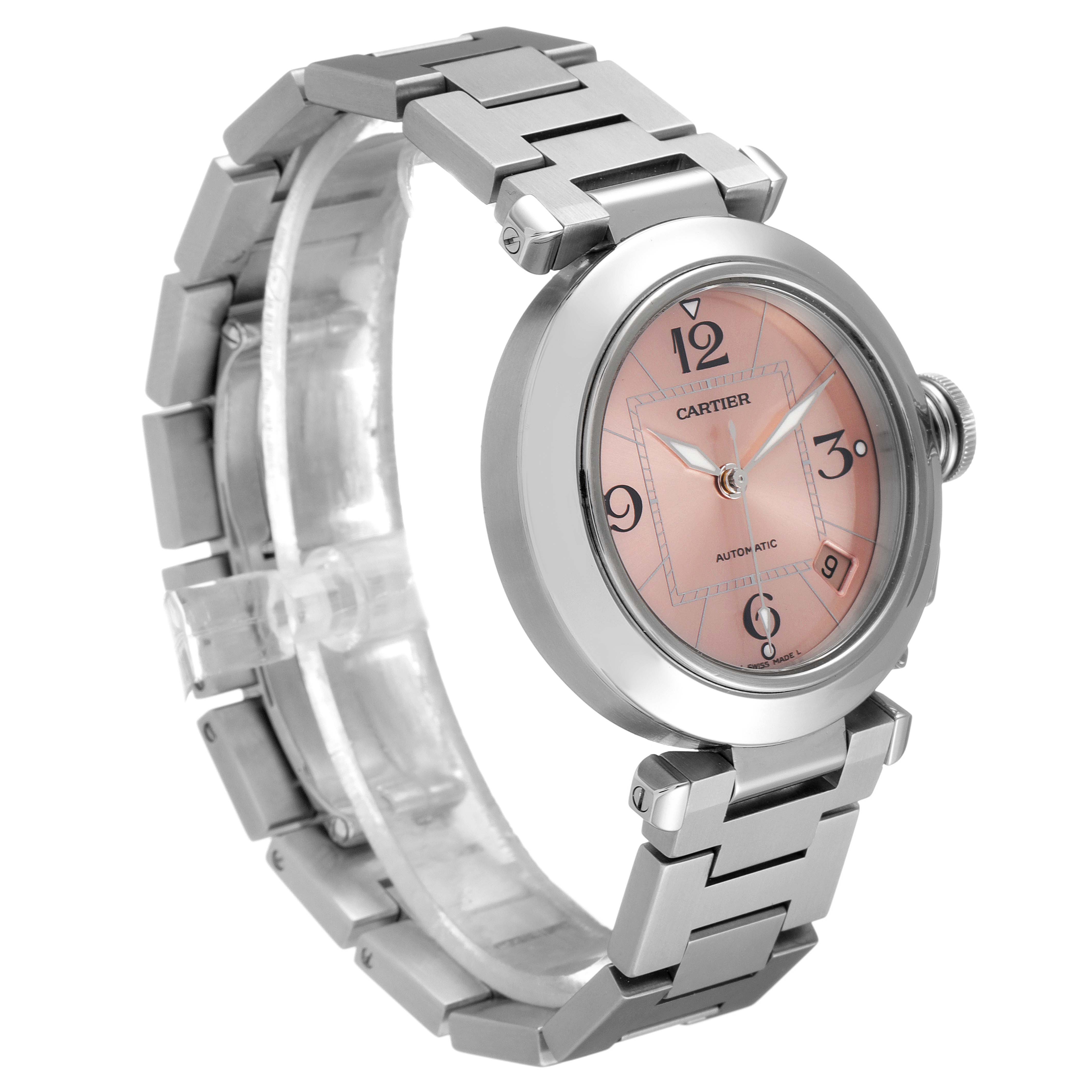 The Cartier Pasha W31075M7 Women's Stainless Steel Pink Dial W31075M7 Women's Stainless Steel Pink Dial watch is shown from a three-quarter angle, highlighting its stainless steel bracelet and salmon-colored dial.
