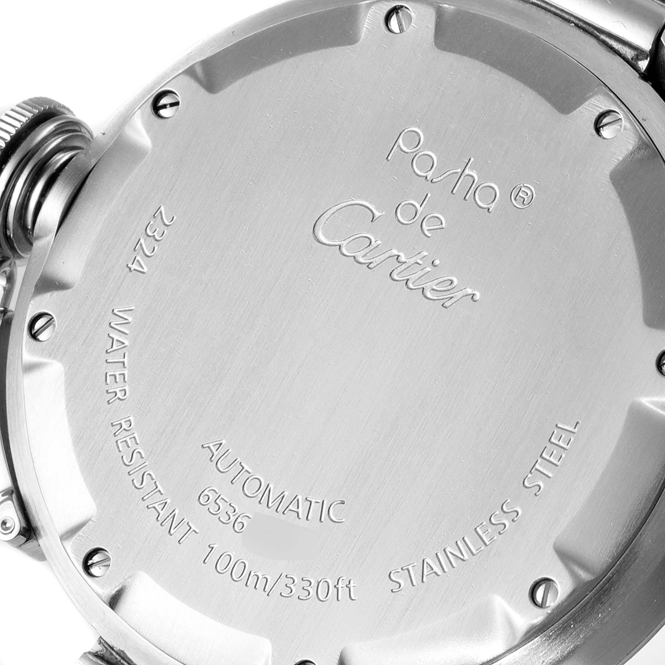 The image shows the back case of a Pasha de Cartier watch, highlighting its engravings and stainless steel body.