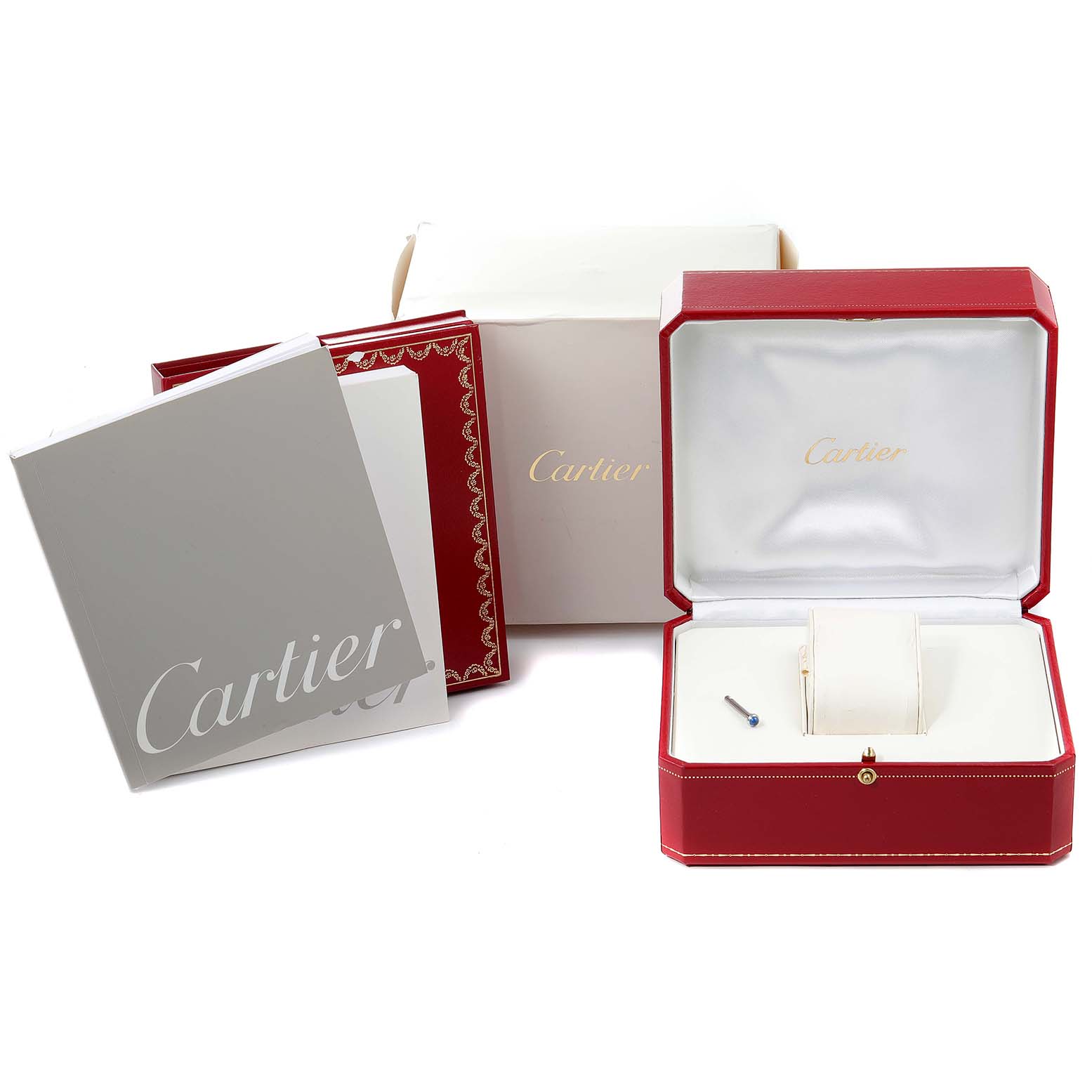 The image shows the packaging and accessories of a Cartier Pasha W31037H3 Men
s Stainless Steel Silver Dial W31037H3 Men
s Stainless Steel Silver Dial watch, including the red box, booklet, and a small tool.