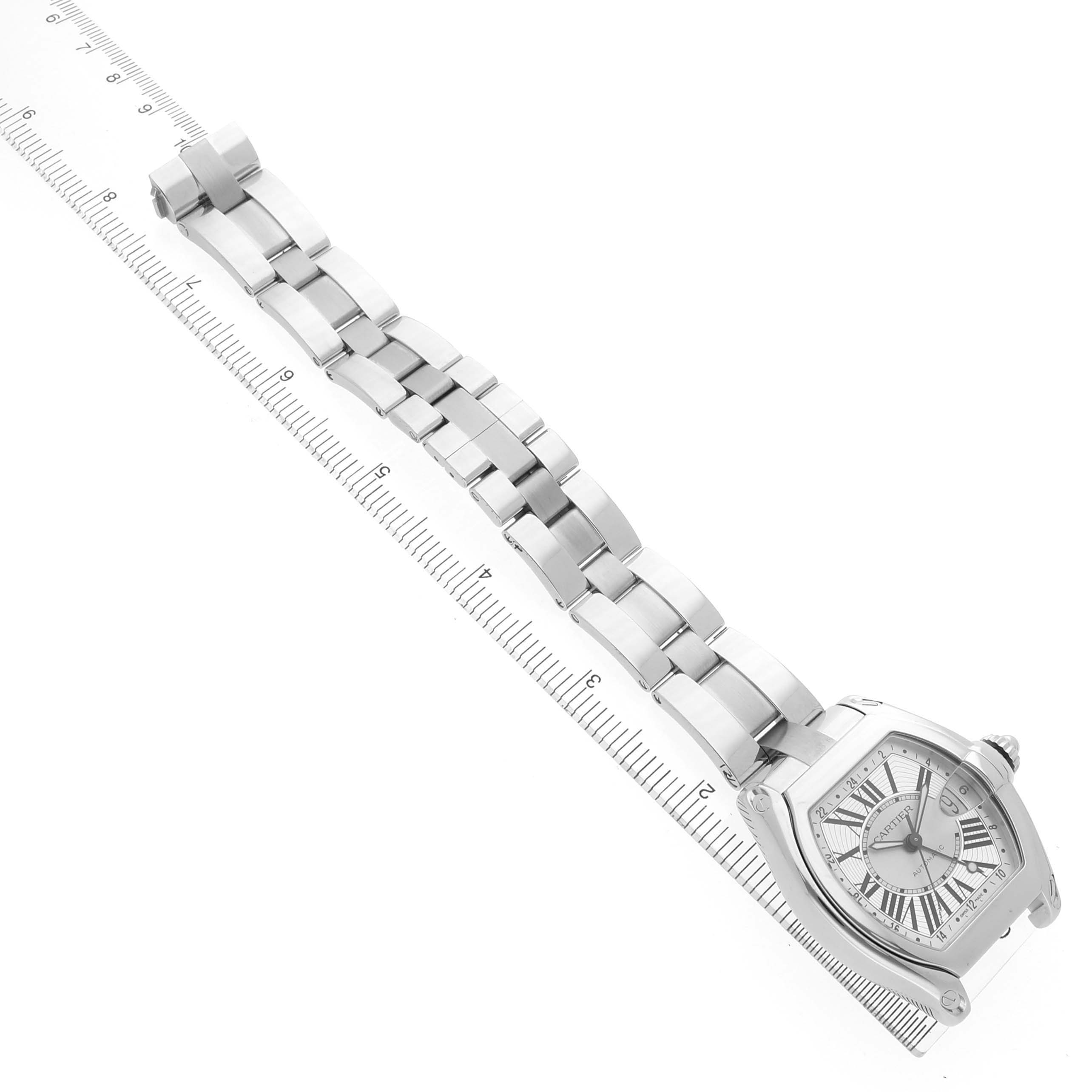 The Cartier Roadster W62032X6 Men's Stainless Steel Silver Dial watch is shown diagonally from above, displaying the face and full metal bracelet.