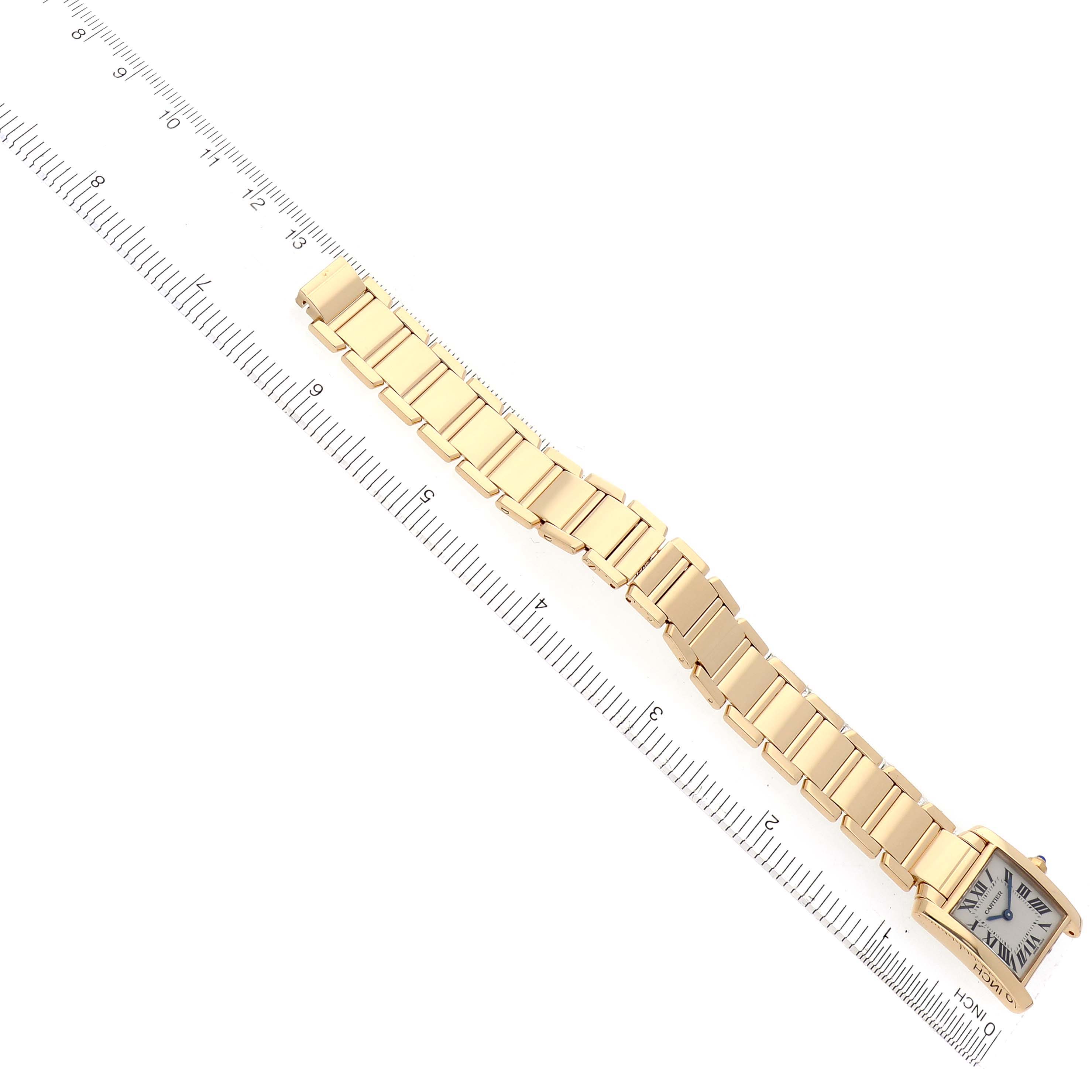 The Cartier Tank Francaise W50002N2 Women
s Yellow Gold Silver Dial W50002N2 Women
s Yellow Gold Silver Dial watch is shown diagonally with the full bracelet and face visible alongside a measuring ruler.