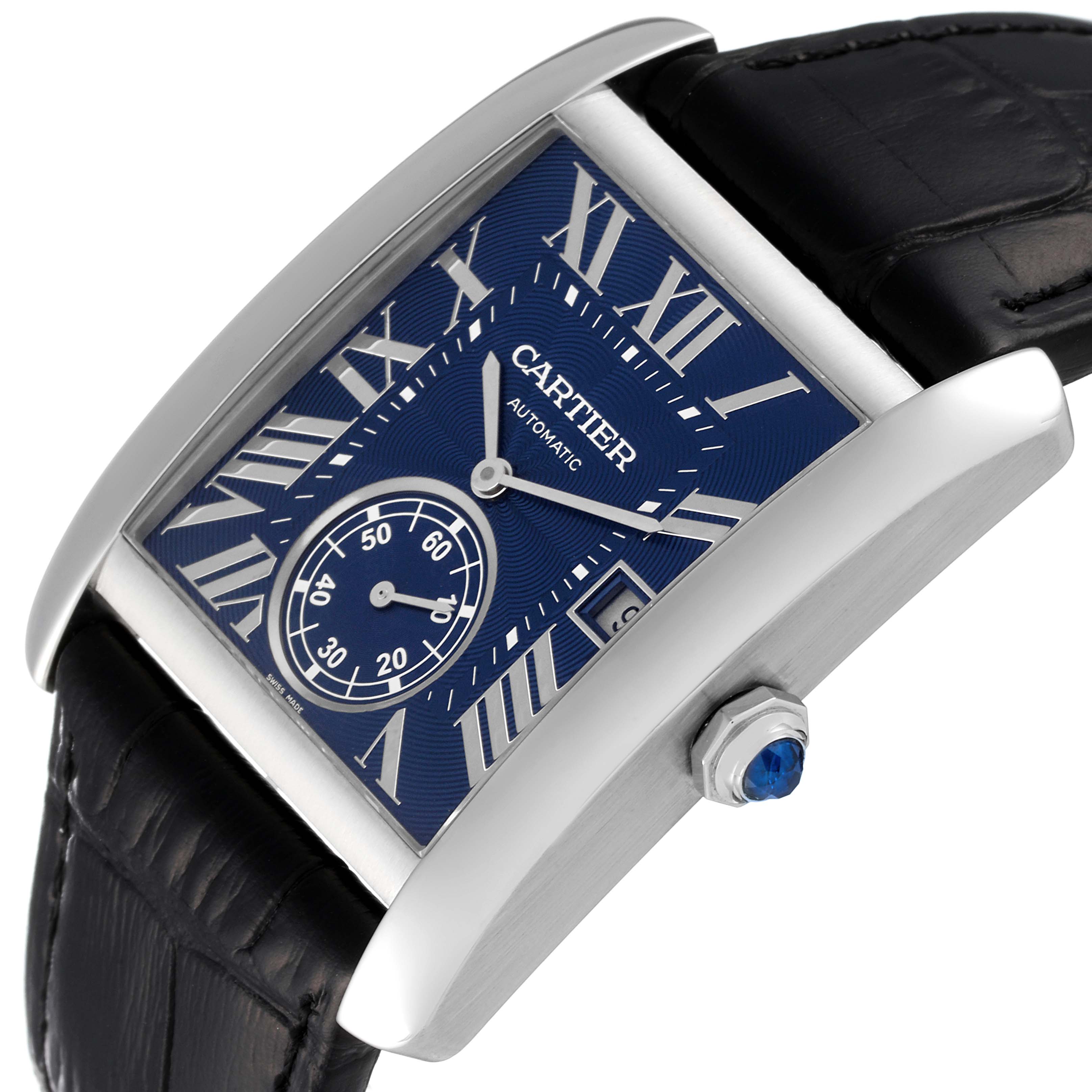 The image shows a Cartier Tank MC WSTA0010 Men
s Stainless Steel Blue Dial WSTA0010 Men
s Stainless Steel Blue Dial watch at an angle displaying the face, crown, and part of the strap.