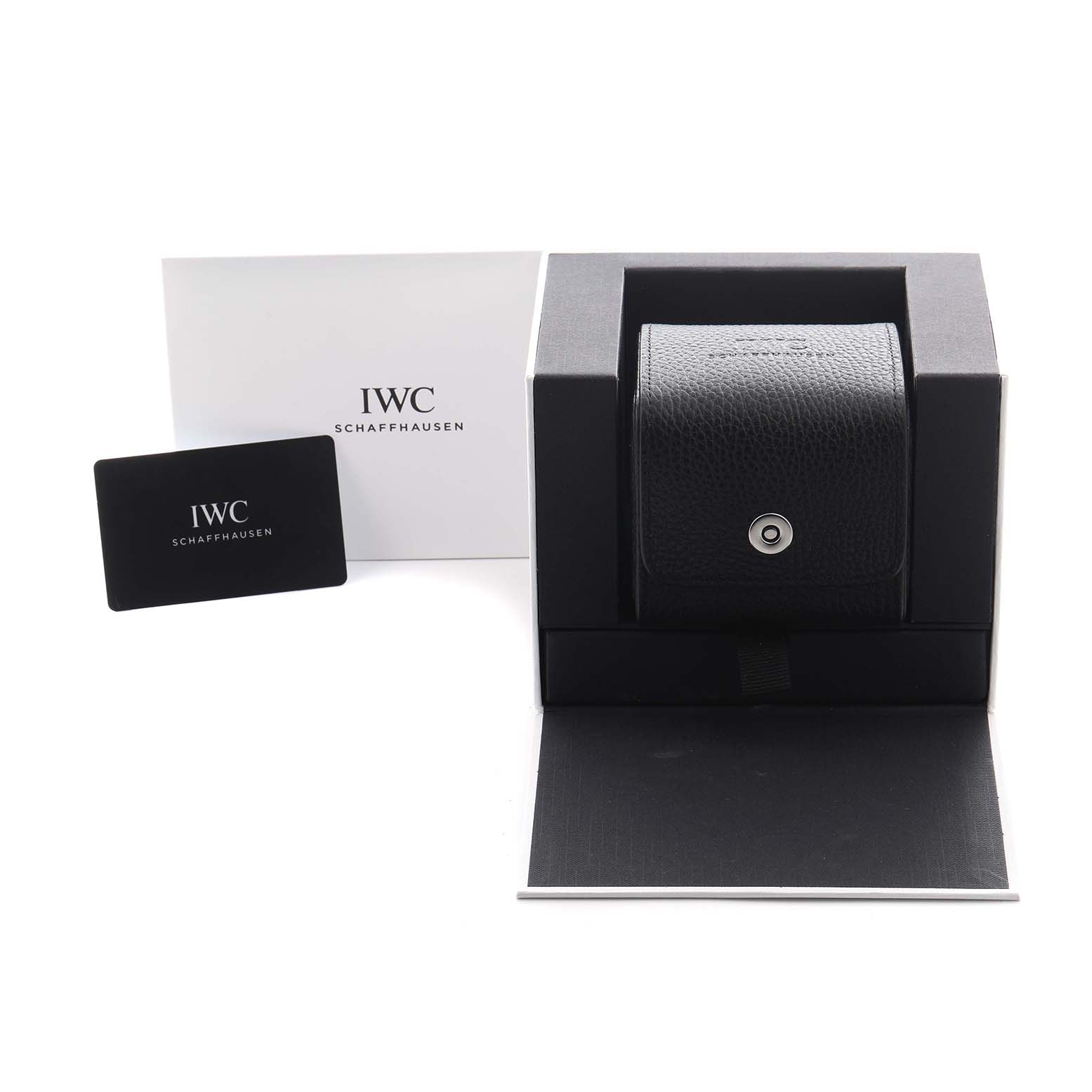 The image shows the packaging and accessories of the IWC Portuguese IW501702 Men
s Stainless Steel Silver Dial IW501702 Men
s Stainless Steel Silver Dial model, including a black case and branded documents.