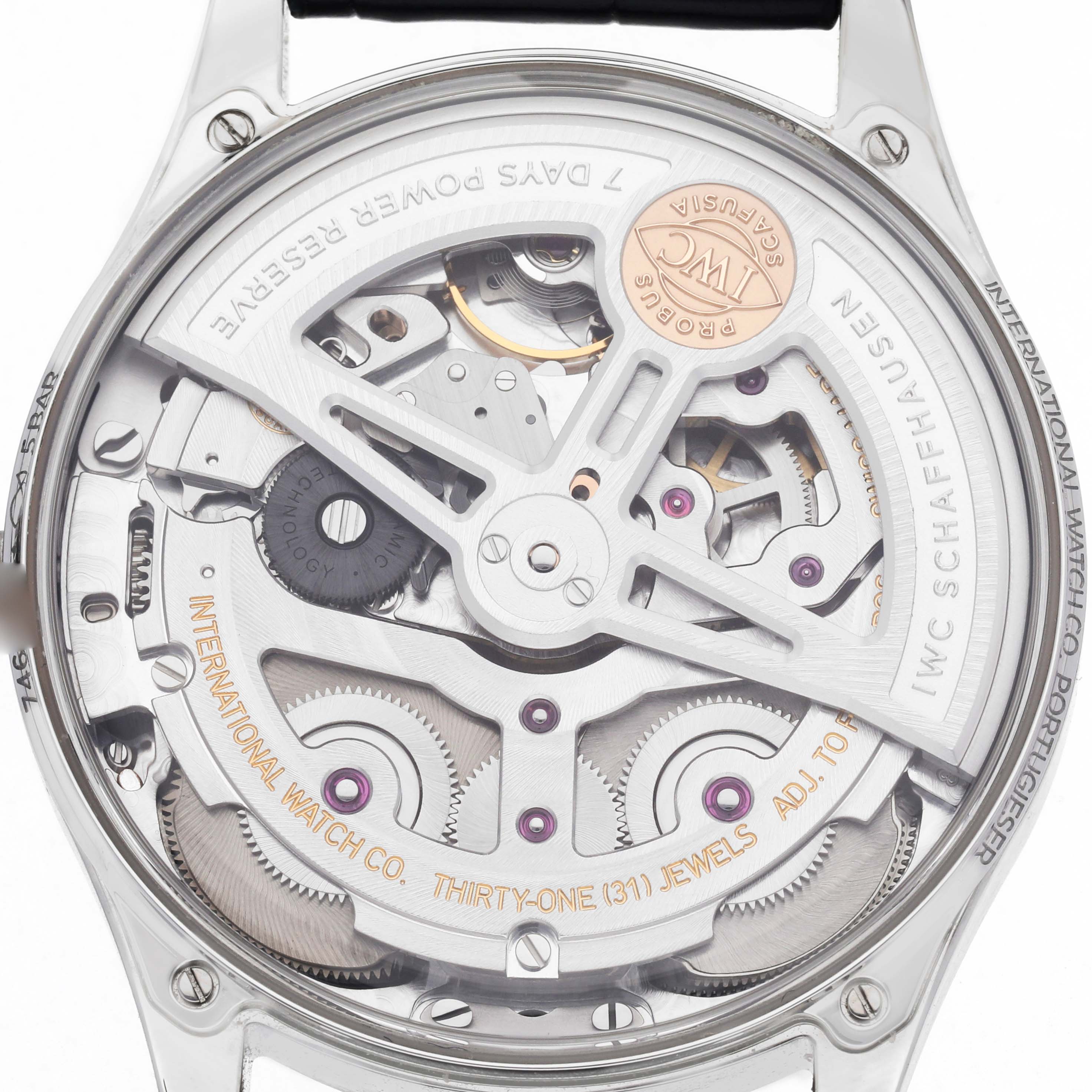 The image shows the rear angle of an IWC Portuguese IW501702 Men
s Stainless Steel Silver Dial IW501702 Men
s Stainless Steel Silver Dial model, displaying its intricate movement and inner mechanisms.